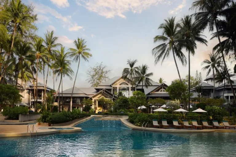 Outdoor Pool Area with Lounge Chairs and Tropical Palm Trees at Bang Tao Beach
