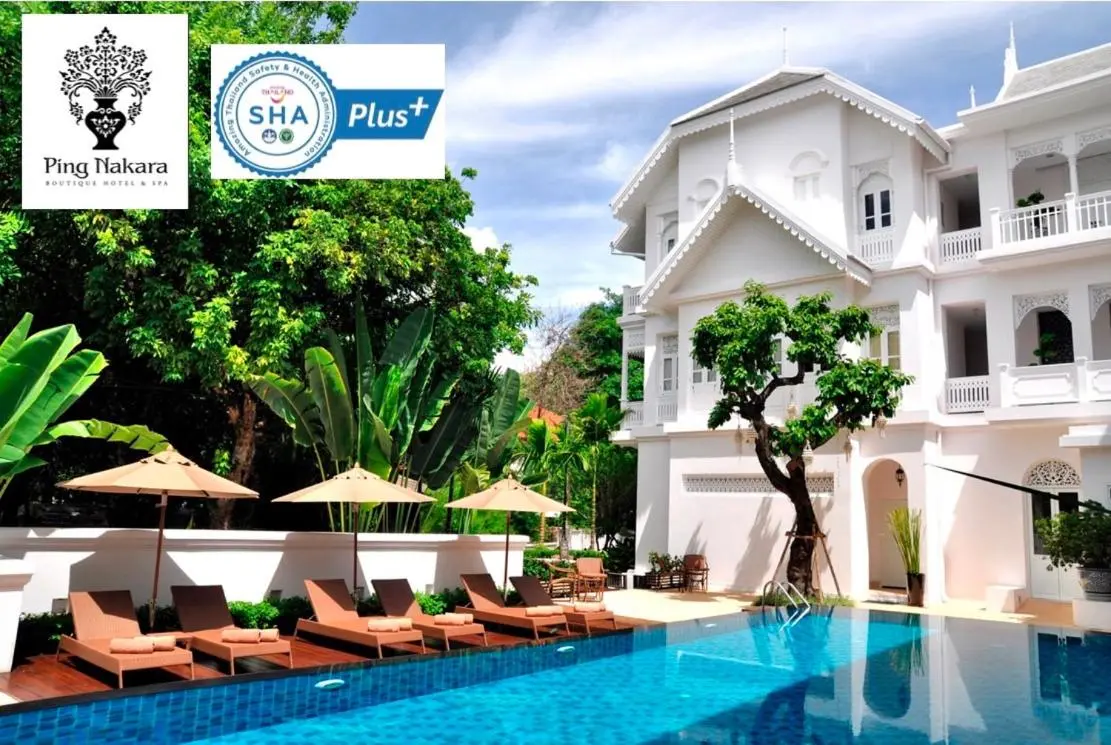 Outdoor Pool Area with Lounge Chairs and Umbrellas in Chang Khlan Chiang Mai