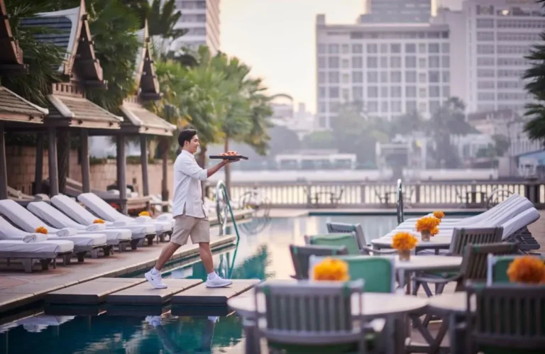 Outdoor Pool Area with Lounge Chairs and Walkway in Khlong San Urban Setting