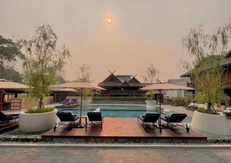 Outdoor Pool Area with Lounge Chairs and Wooden Deck in Chiang Mai Courtyard