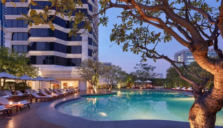 Outdoor Pool Area with Lounge Seating and Ambient Lighting in Pathumwan Bangkok