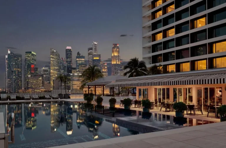 Outdoor Pool Area with Lounge Seating and City Views in Marina Bay