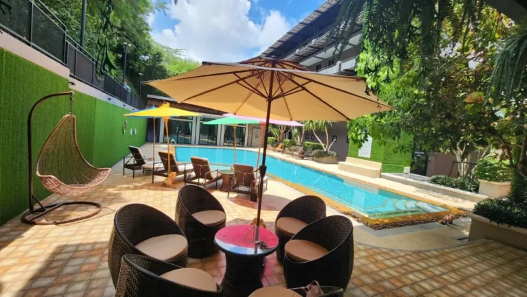 Outdoor Pool Area with Lounge Seating and Colorful Umbrellas in Ban Bo Rae