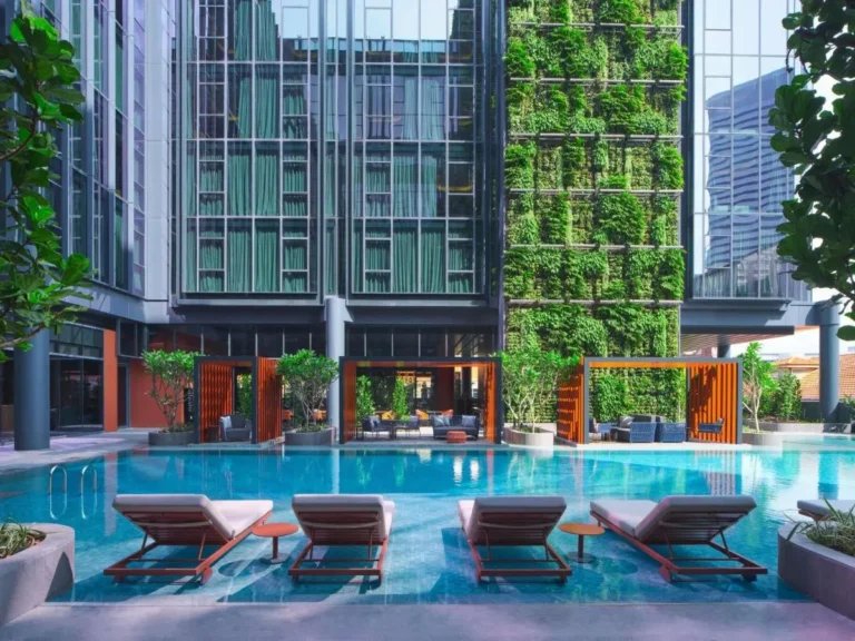 Outdoor Pool Area with Lounge Seating and Green Wall in City Hall District