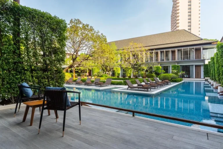Outdoor Pool Area with Lounge Seating and Greenery in Sathorn Urban Setting