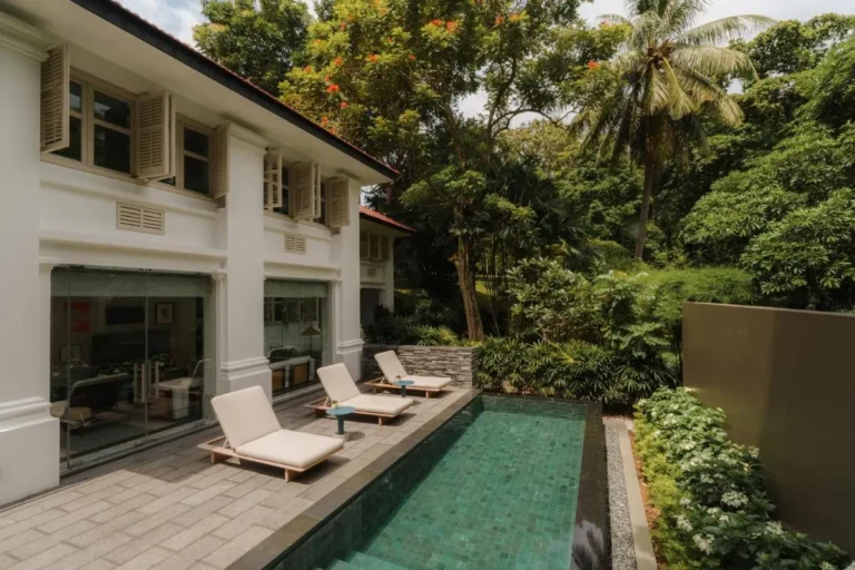Outdoor Pool Area with Lounge Seating and Greenery on Sentosa Island