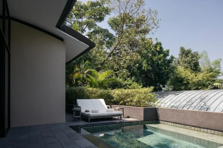 Outdoor Pool Area with Lounge Seating and Greenery on Sentosa Island