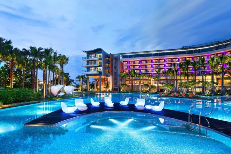 Outdoor Pool Area with Lounge Seating and Palm Trees on Sentosa Island