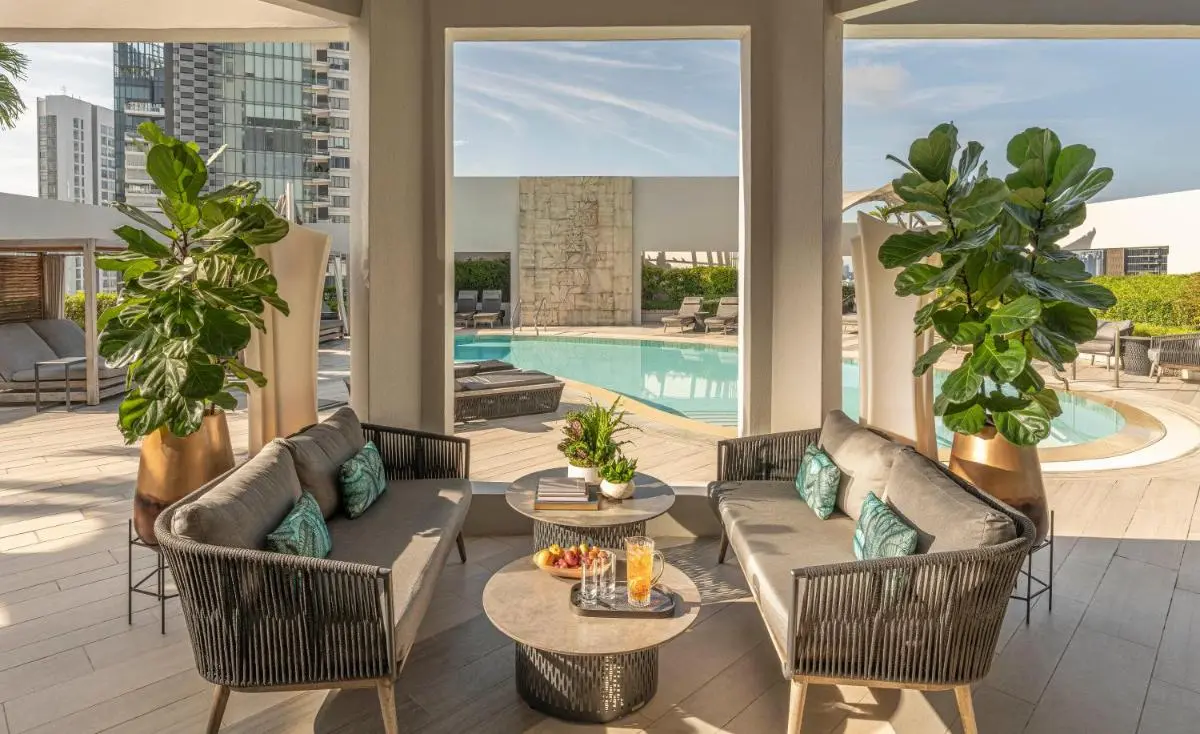 Outdoor Pool Area with Lounge Seating and Shaded Cabanas in Orchard Singapore