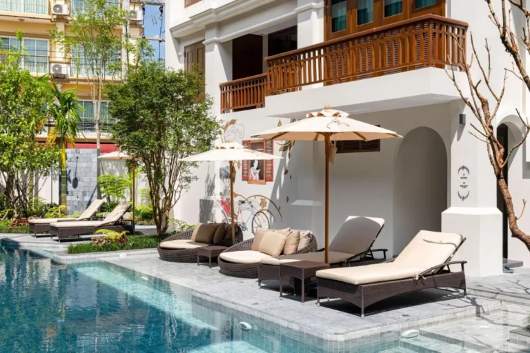 Outdoor Pool Area with Lounge Seating and Umbrellas in Chiang Mai City