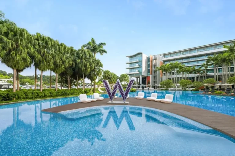 Outdoor Pool Area with Lounge Seating and Waterfront Views on Sentosa Island