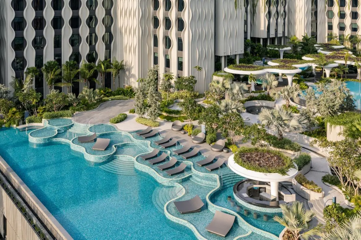 Outdoor Pool Area with Loungers and Garden Features on Sentosa Island