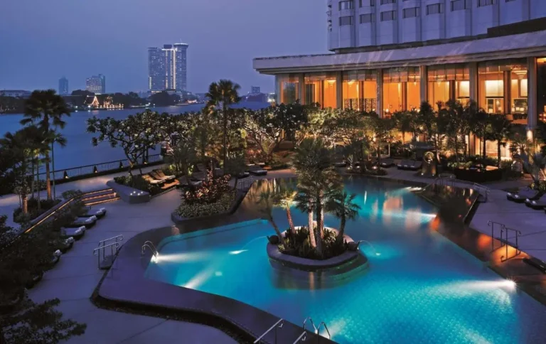 Outdoor Pool Area with Palm Trees and Urban Views in Bang Rak Bangkok