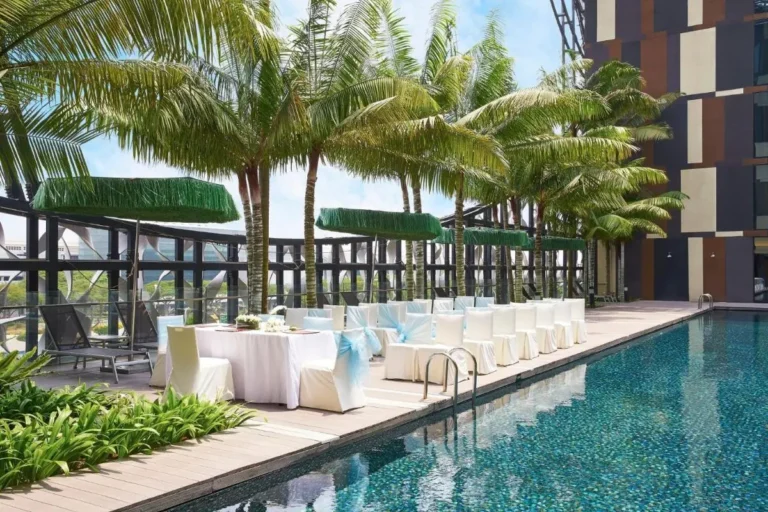 Outdoor Pool Area with Seating and Lounge Chairs in Changi
