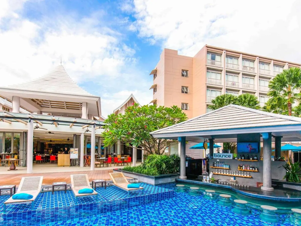 Grand Mercure Phuket Patong Outdoor Pool Area with Swim-Up Bar and Lounge Seating at Patong Beach