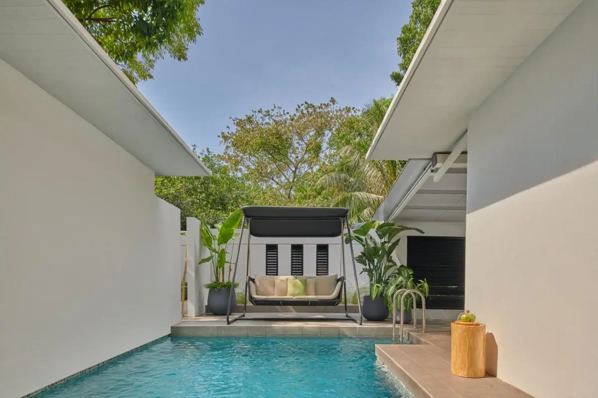 Outdoor Pool Area with Swing Seating and Greenery in Singapore