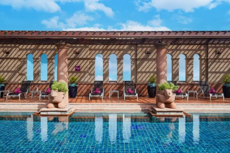 Outdoor Pool Area with Tiled Deck and Lounge Chairs in Bang Rak Bangkok