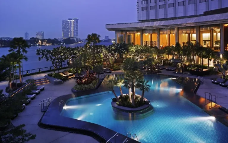 Outdoor Pool Area with Tropical Landscaping and Waterfront Views in Bang Rak