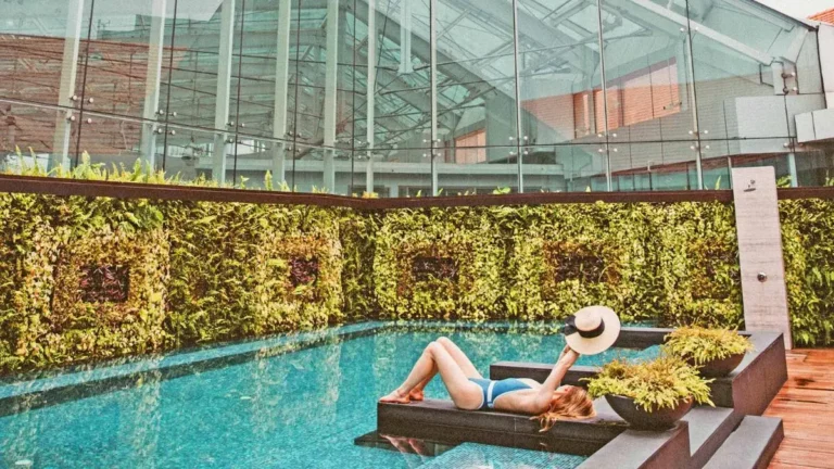 Outdoor Pool Area with Vertical Garden and Relaxation Platform Near City Hall