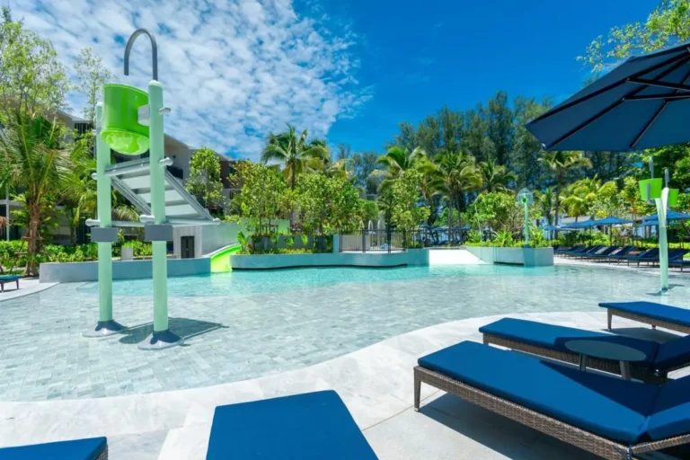 Outdoor Pool Area with Water Play Structure and Lounge Seating at Mai Khao Beach
