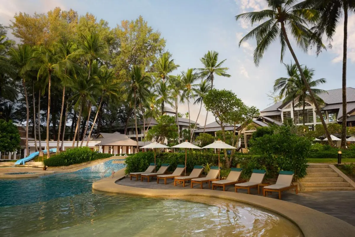 Dusit Thani Laguna Phuket Outdoor Pool Area with Water Slide and Lounge Seating at Bang Tao Beach Resort Thailand