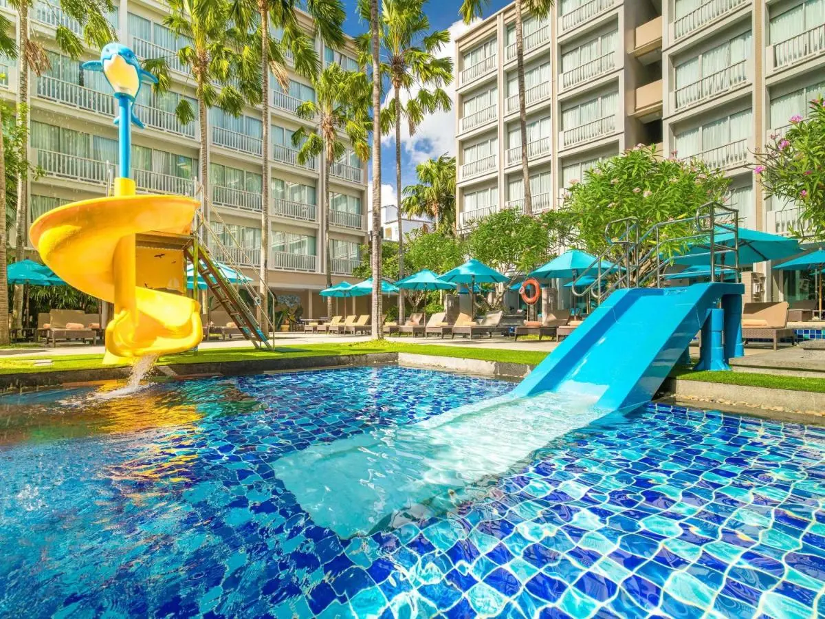 Outdoor Pool Area with Water Slides and Lounge Chairs at Patong Beach