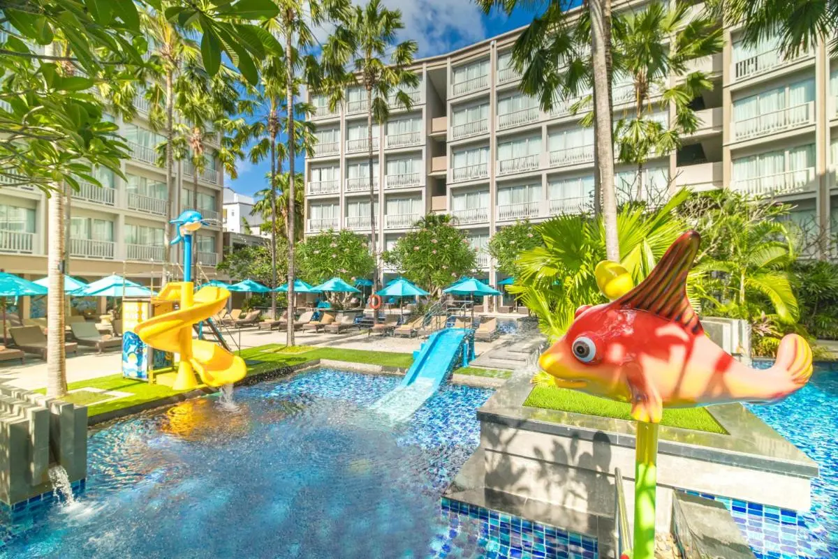 Outdoor Pool Area with Water Slides and Tropical Landscaping at Patong Beach