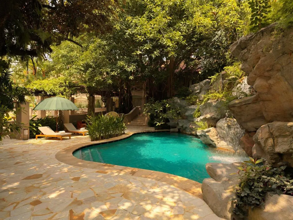 Outdoor Pool Area with Waterfall and Lounge Seating on Sentosa Island