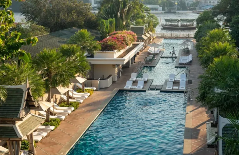 Outdoor Pool Complex with Lounge Chairs and Tropical Landscaping in Khlong San Bangkok