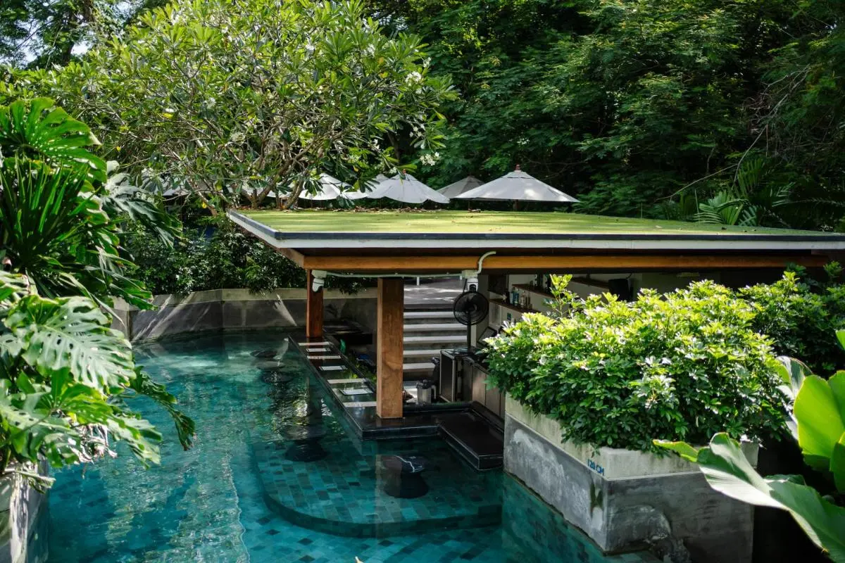 The Nature Phuket Outdoor Pool with Swim-Up Bar Surrounded by Lush Tropical Greenery at Patong Beach