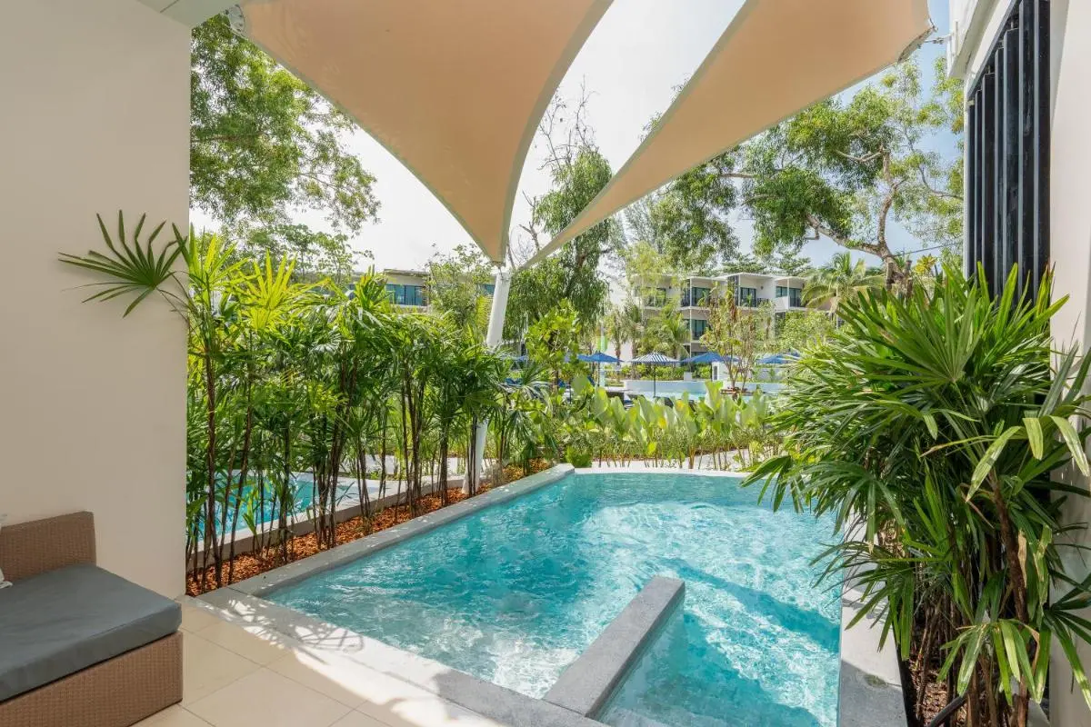 Outdoor Pools and Relaxation Areas with Canopies and Tropical Greenery at Mai Khao Beach