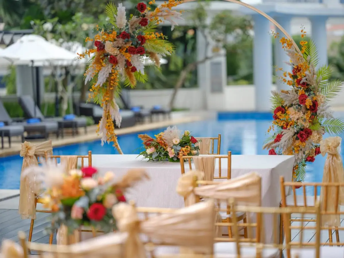 Outdoor Poolside Event Setup with Floral Arch and Lounge Seating at Robertson Quay
