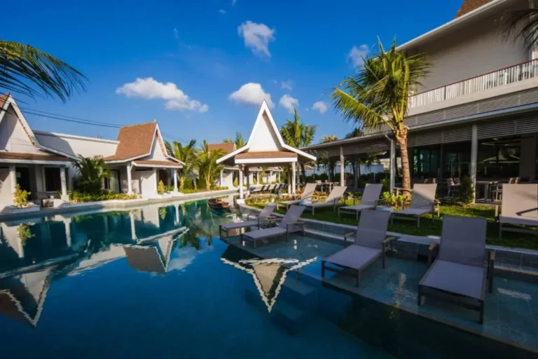 Outdoor Rectangular Pool Area with Lounge Chairs and Tropical Landscaping in Thalang