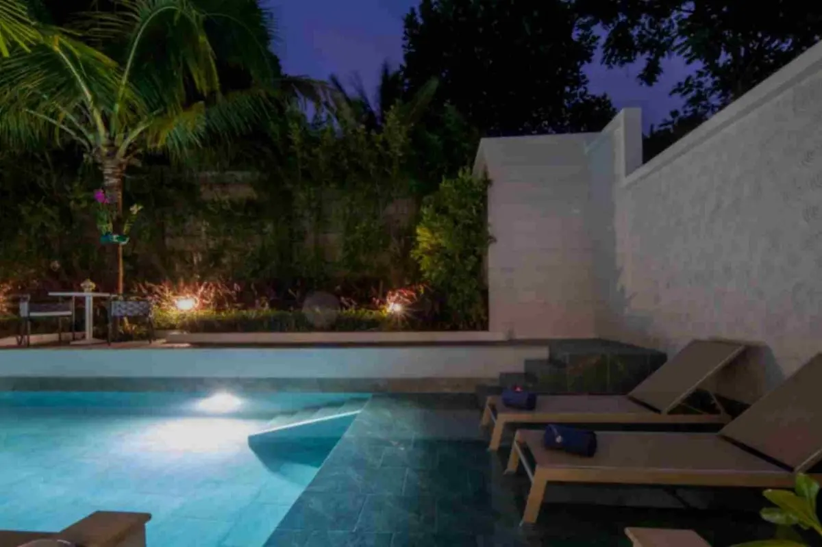 Outdoor Rectangular Pool Area with Lounge Seating and Ambient Lighting at Night in Phuket Town