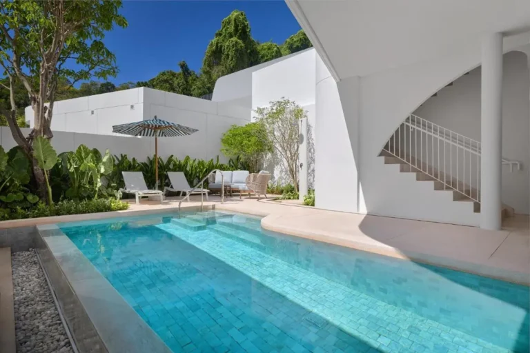 Outdoor Rectangular Pool Area with Lounge Seating and Modern Architecture at Panwa Beach