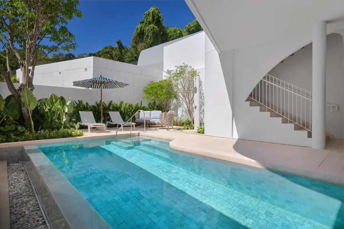 Outdoor Rectangular Pool Area with Lounge Seating and Modern Architecture at Panwa Beach