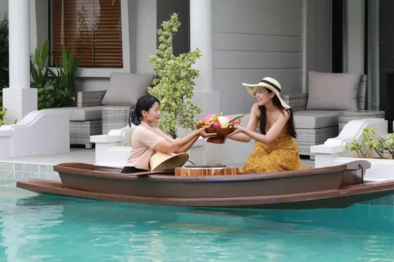 Outdoor Rectangular Pool with Floating Wooden Boat and Patio Seating in Thalang