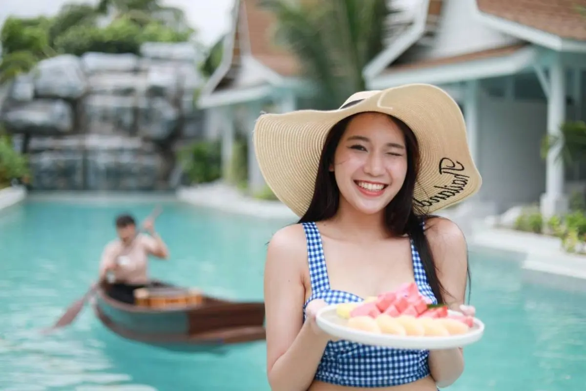Outdoor Rectangular Pool with Wooden Boat and Tropical Surroundings in Thalang