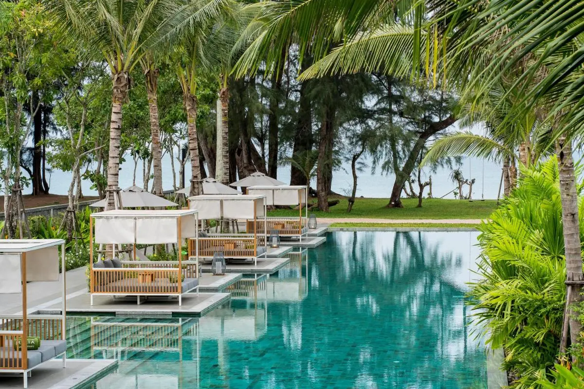 Meliá Phuket Mai Khao Outdoor Rectangular Swimming Pool with Daybeds and Tropical Surroundings at Mai Khao Beach