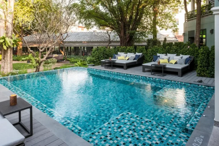 Outdoor Rectangular Swimming Pool with Lounge Beds and Garden in Phra Nakhon