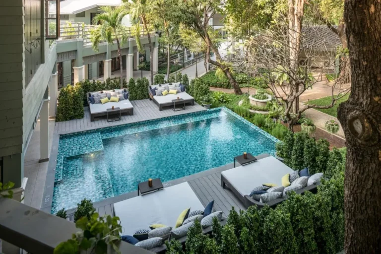 Outdoor Rectangular Swimming Pool with Lounge Beds and Garden in Phra Nakhon