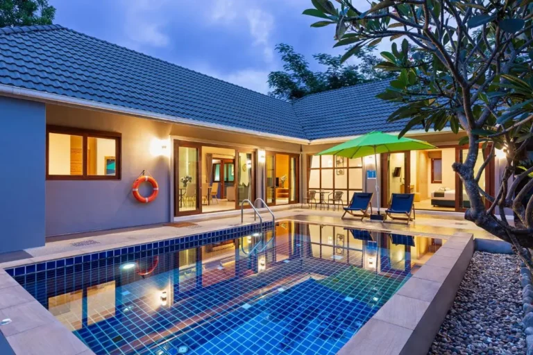 Outdoor Rectangular Swimming Pool with Lounge Chairs and Garden at Rawai Beach