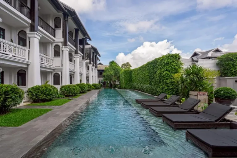 Outdoor Rectangular Swimming Pool with Lounge Chairs and Greenery in Phra Sing Chiang Mai