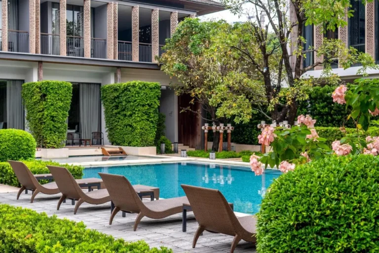 Outdoor Rectangular Swimming Pool with Lounge Chairs and Greenery in Sathorn Bangkok