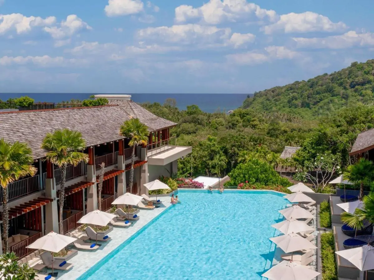 Outdoor Rectangular Swimming Pool with Lounge Chairs and Ocean View at Patong Beach