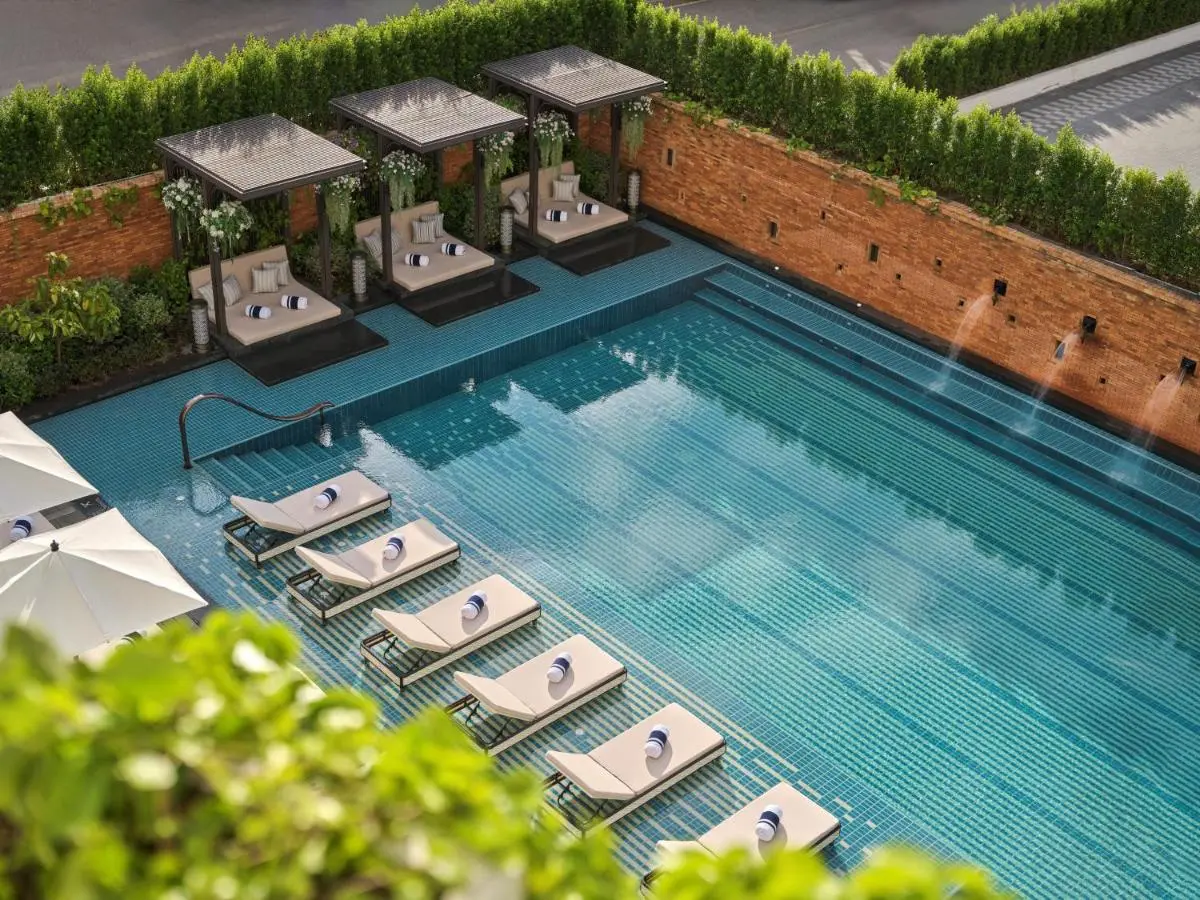 Outdoor Rectangular Swimming Pool with Lounge Chairs and Shaded Cabanas in Chang Khlan Chiang Mai