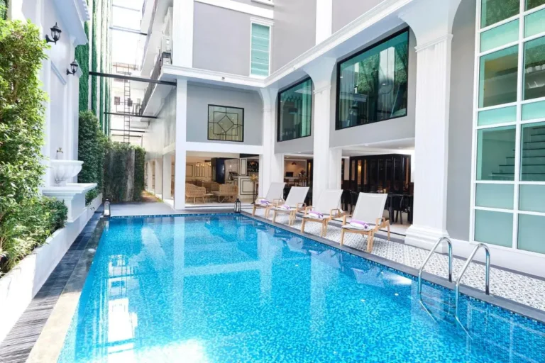 Outdoor Rectangular Swimming Pool with Lounge Chairs and Tiled Deck in Phra Nakhon