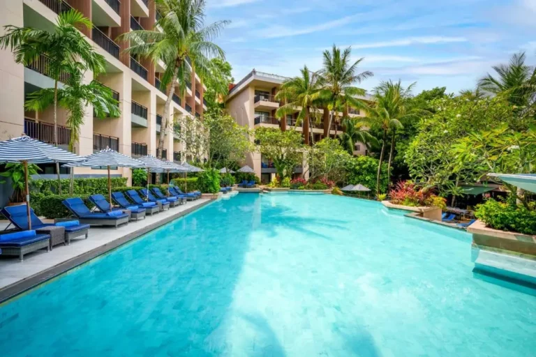 Outdoor Rectangular Swimming Pool with Lounge Chairs and Tropical Surroundings at Kata Beach