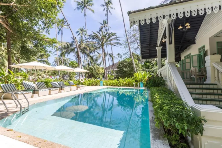 Outdoor Rectangular Swimming Pool with Lounge Chairs and Tropical Surroundings at Panwa Beach