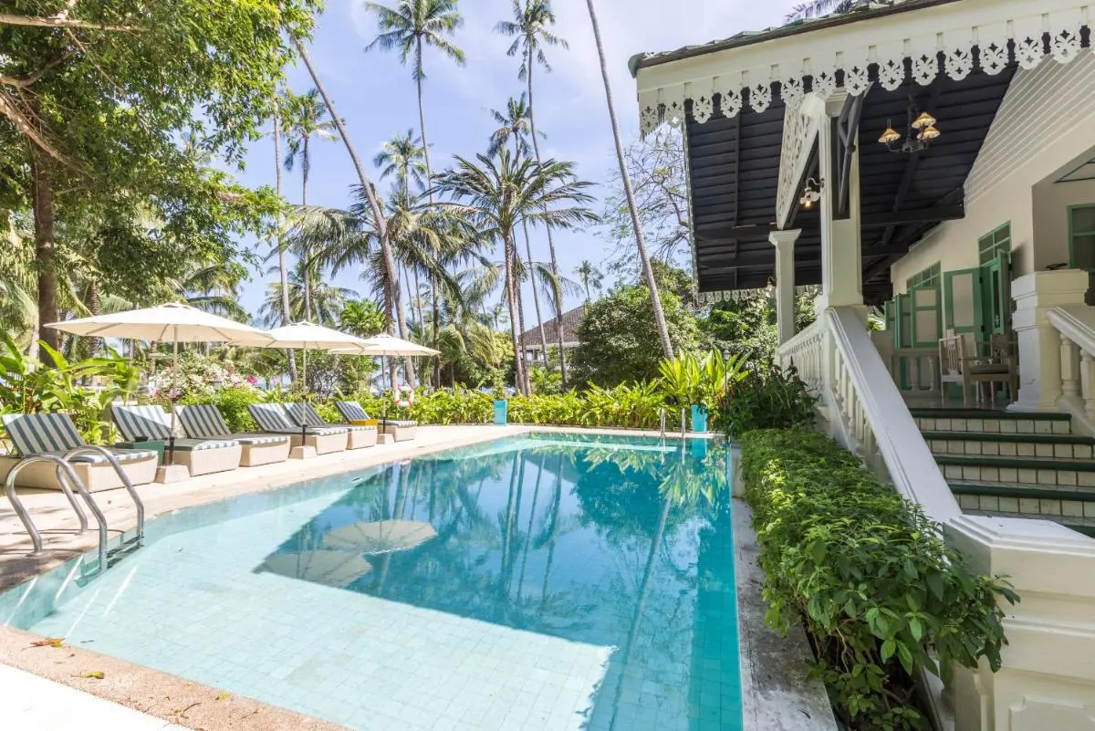Outdoor Rectangular Swimming Pool with Lounge Chairs and Tropical Surroundings at Panwa Beach